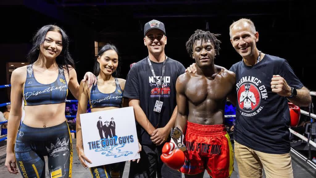 Fighter, coaches and ring crew celebrating in the ring